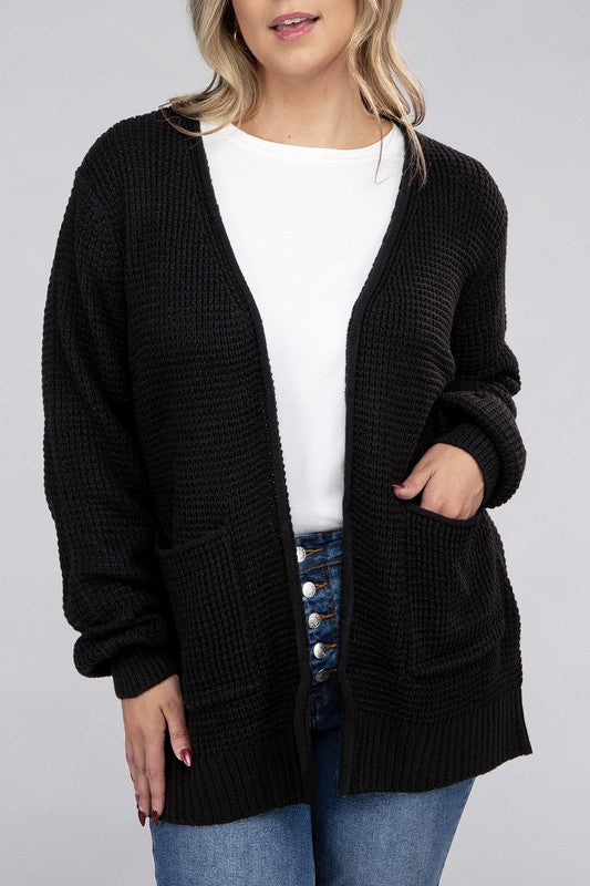 Curvy plus-size waffle-pattern open cardigan sweater in black, with long sleeves, oversized fit, and pockets.