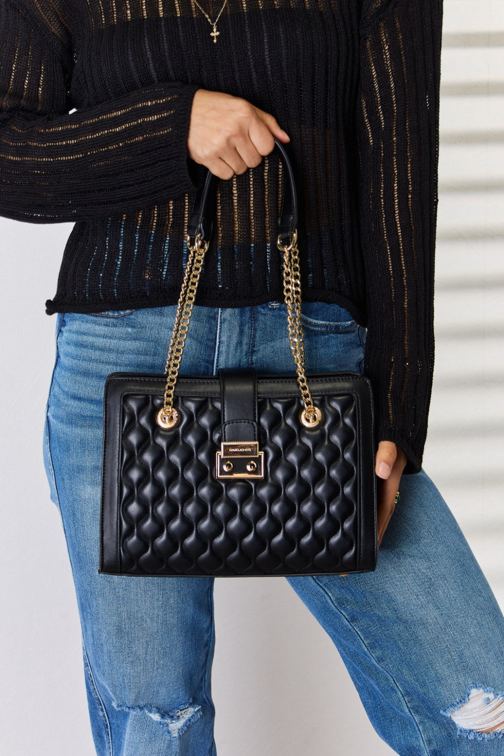 Black small quilted PU leather handbag in a stylish design, featuring a sleek appearance and multiple compartments.