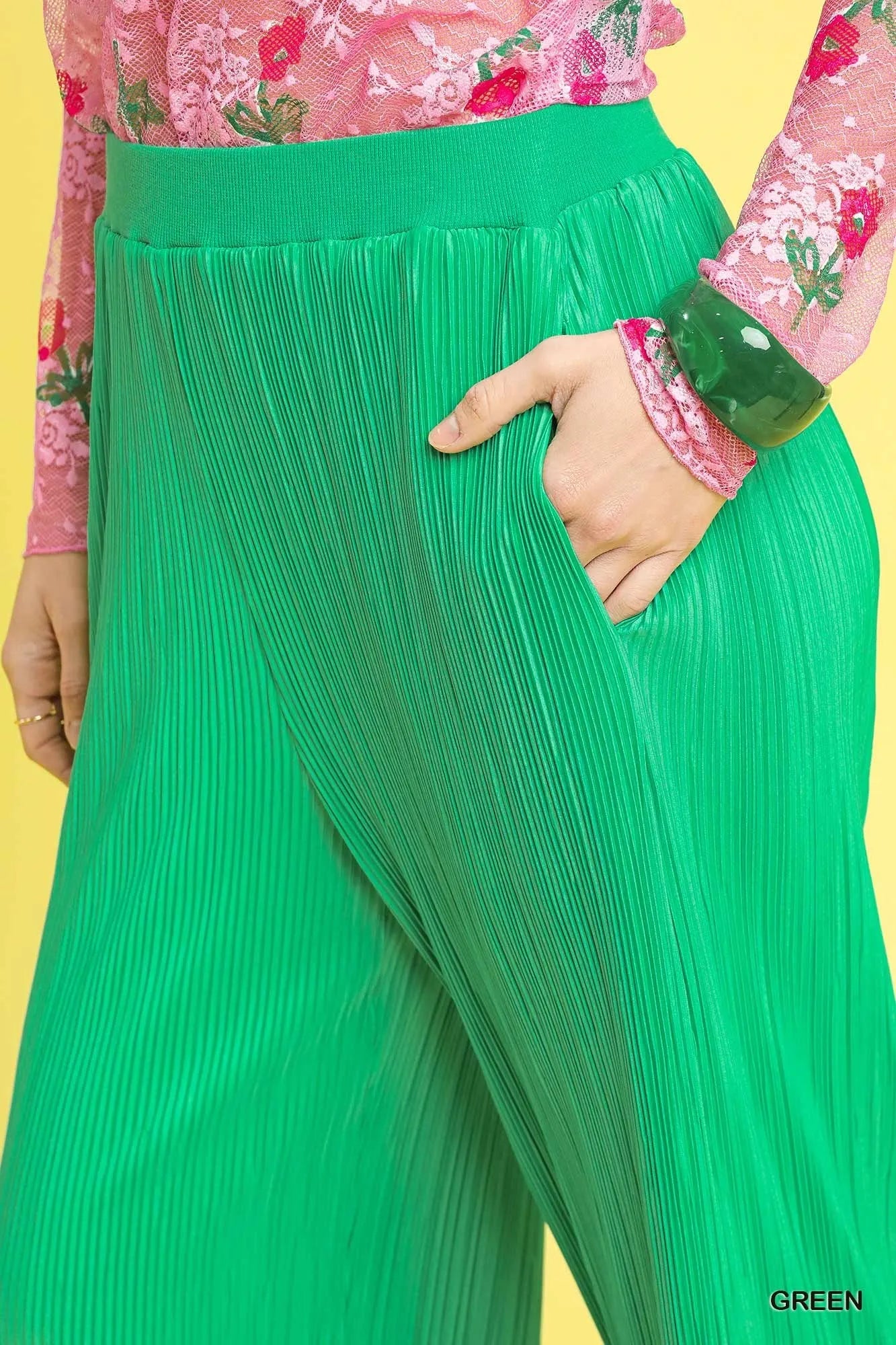 Textured green fabric of Hadlee Pants with elastic high waist and flowy detail.