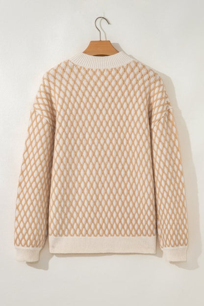 Ximena Rhombus Textured Knit Sweater back view on hanger with ribbed hem detail.