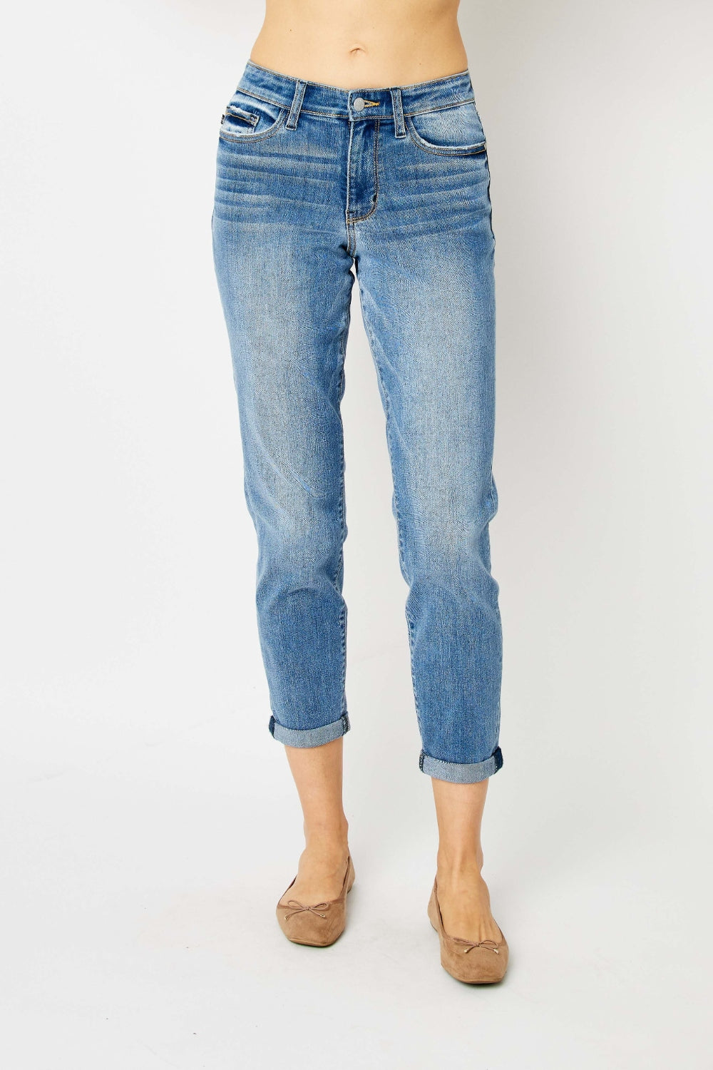 Mid-rise slim fit jeans with cuffed hems and a zip fly. Medium wash, highly stretchy fabric.