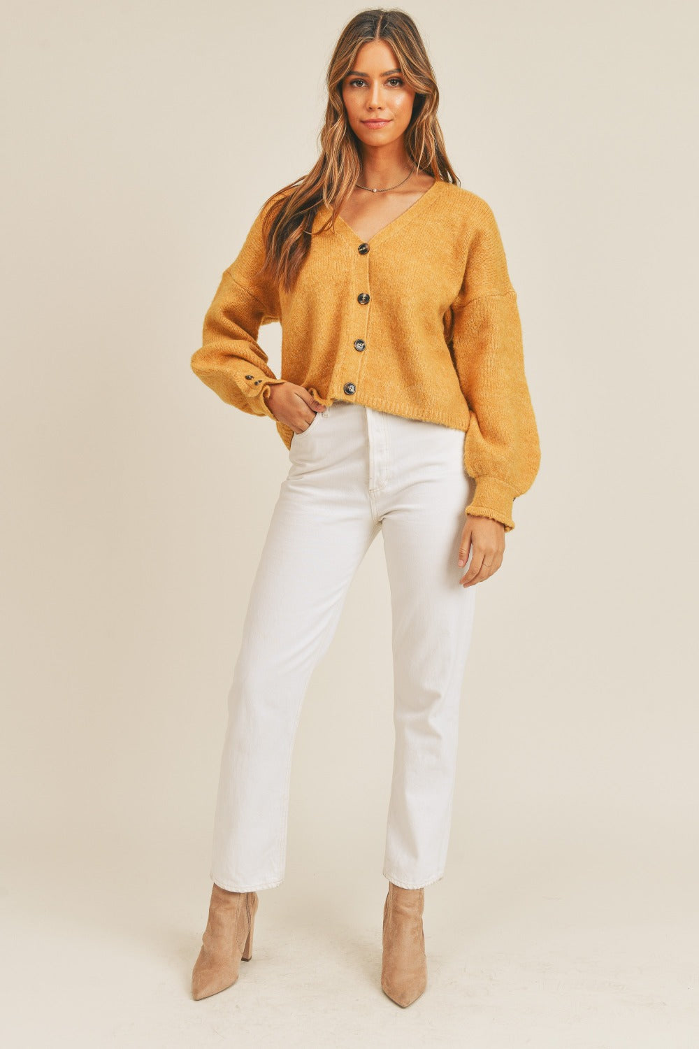 Women's mustard cardigan with a V-neckline, long sleeves, button-down closure, and a relaxed fit.