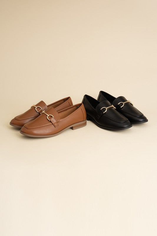 Black and Cognac Horsebit Loafers with guitar motif, featuring horsebit detailing, slip-on style, and flat heel.