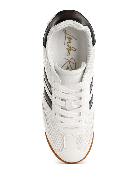 Top view of white Blaster sneaker showcasing black stripes, lace-up closure, and breathable mesh upper – lightweight sporty design by Rag Company