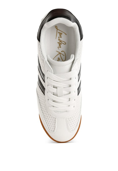 Top view of white Blaster sneaker showcasing black stripes, lace-up closure, and breathable mesh upper – lightweight sporty design by Rag Company