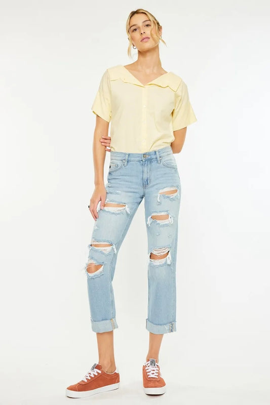 Full body view of model wearing Cordelia Mid Rise Distressed Boyfriend Jeans by Kancan, styled with sneakers and a button-down shirt for a casual chic look.