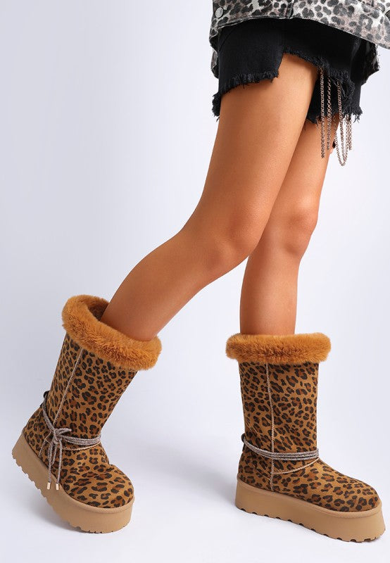 Side view of model in leopard boots showing wraparound tie and chunky sole.