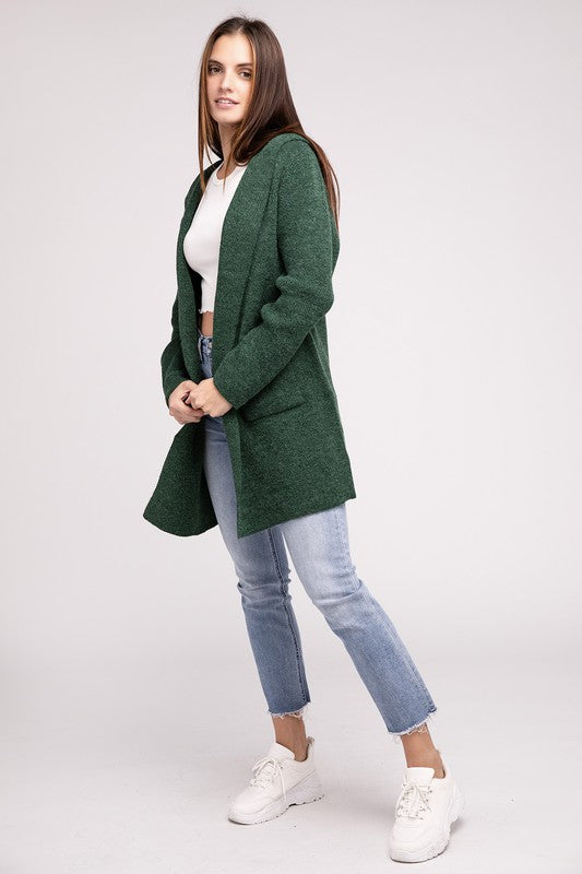 Dark Green sweater cardigan with long sleeves, front pockets, and a hooded neckline. 