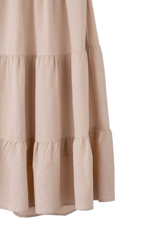 Tiered maxi skirt with elastic waistband in beige. Flowy silhouett, lined for full coverage.