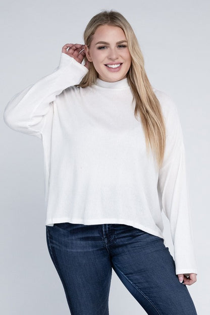 Plus size model wearing Raya Curvy Plus Drop Shoulder Top in off white with mock neck, front view.