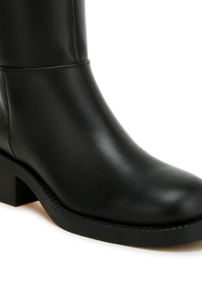 Close up of Soora Block Heel Calf Boots in black showing paneling and heel detail