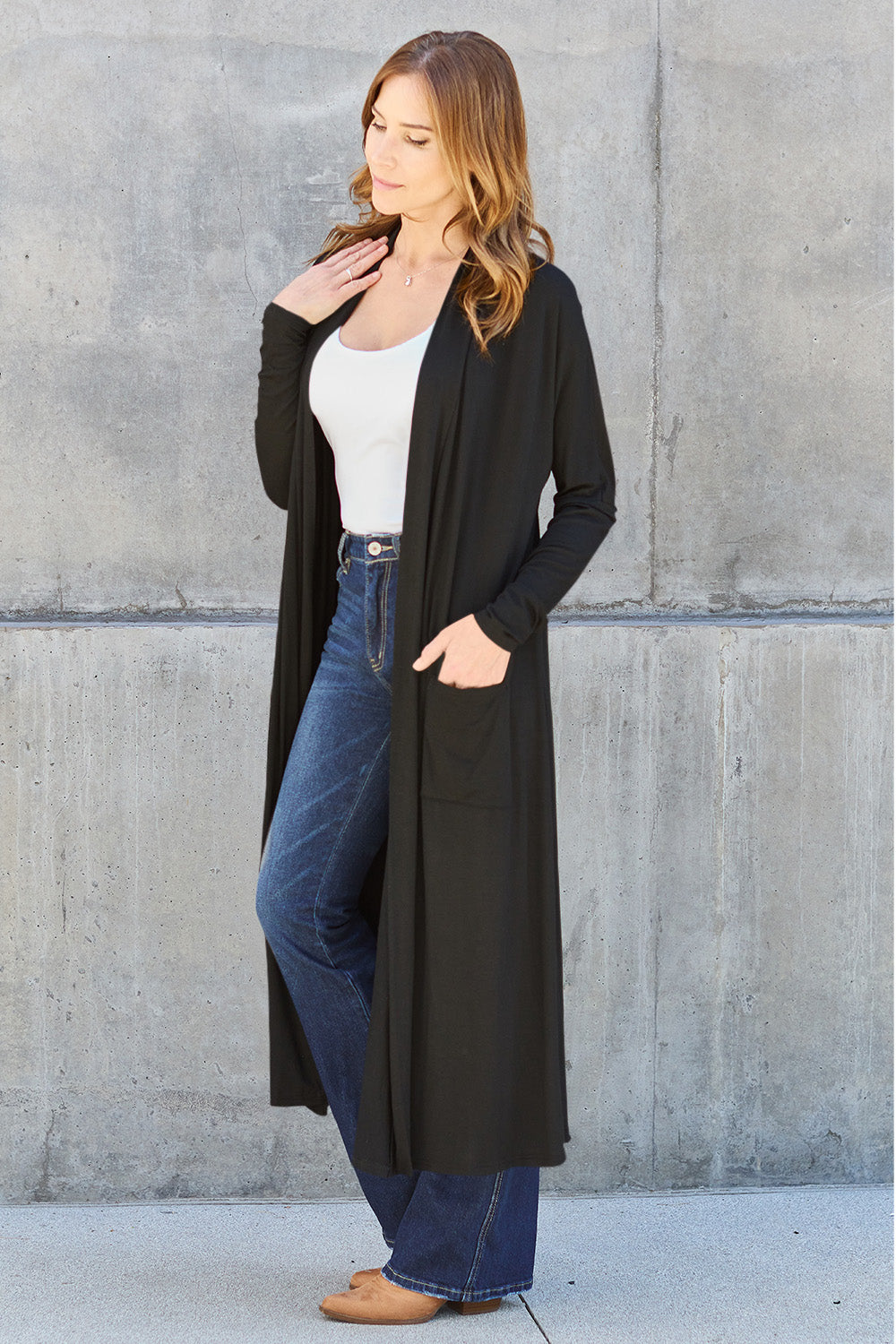 Black open-front long-sleeve cover-up with a flowy design and pockets, perfect for layering on breezy days.