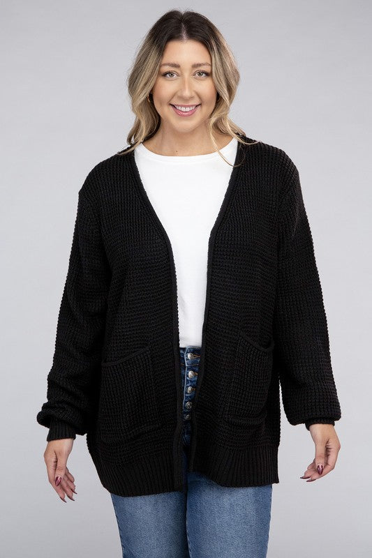 Curvy plus-size waffle-pattern open cardigan sweater in black, with long sleeves, oversized fit, and pockets.