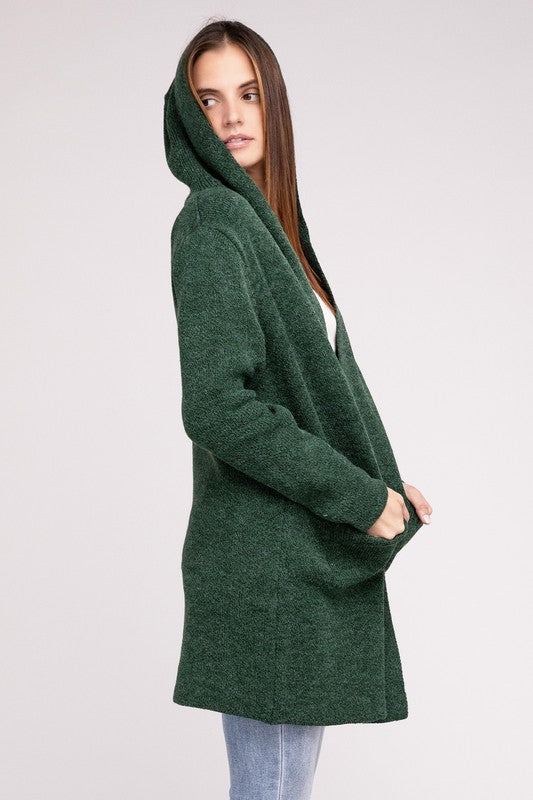 Dark Green sweater cardigan with long sleeves, front pockets, and a hooded neckline. 