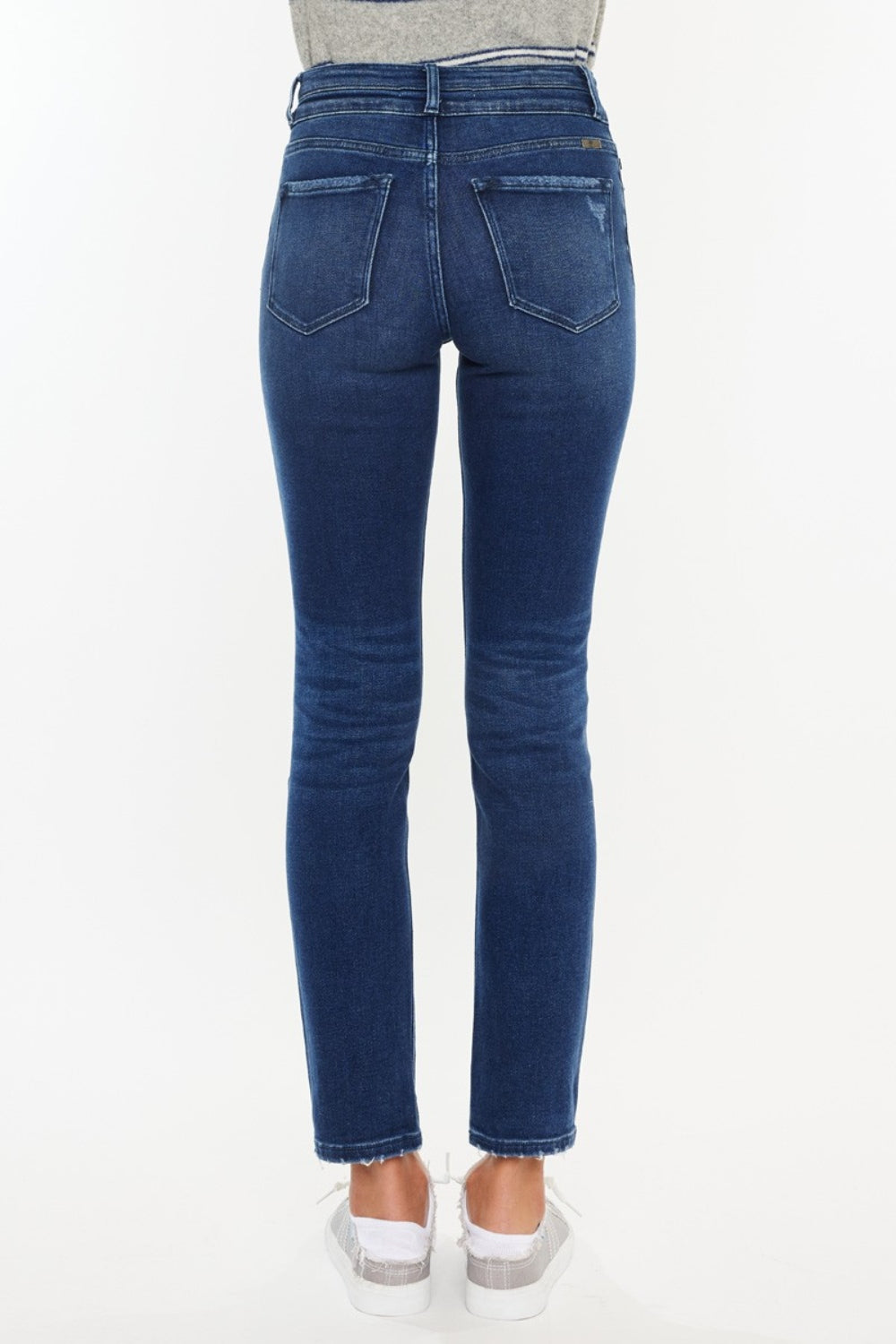 Dark high-rise slim straight jeans with a slightly stretchy fit, raw hem, and pockets