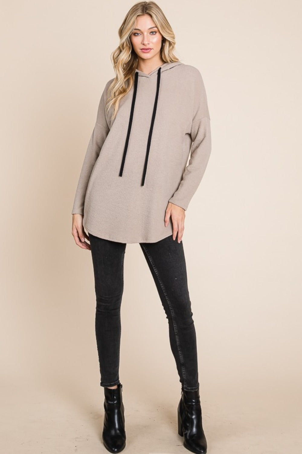 Toupe hoodie with a black drawstring hood, long sleeves, and a relaxed fit. Features a soft brushed interior and dropped shoulders.