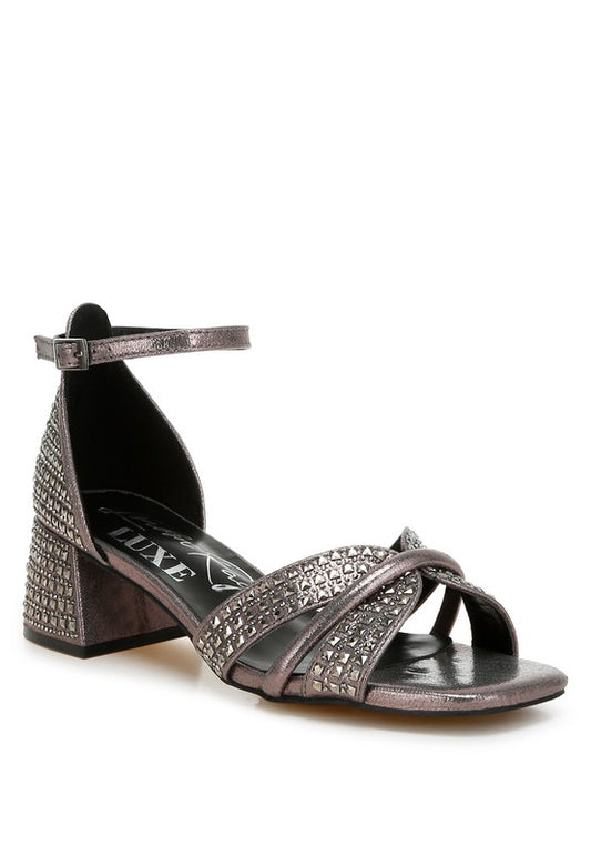 Peweter rhinestone-embellished sandals with a low block heel, open square toe, and adjustable buckle ankle strap.