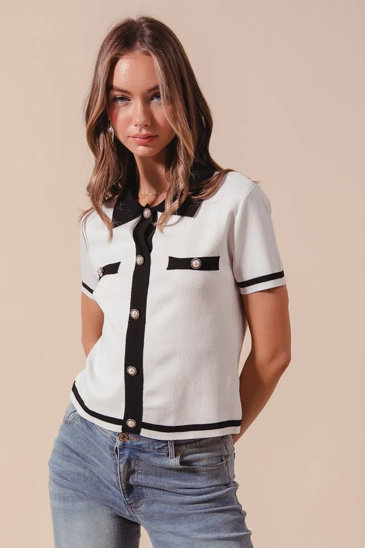 Front-facing view of the Novah Button Down Knitted Sweater Shirt Top in ivory with black trim, showcasing the adorable buttons and chic contrast detailing.