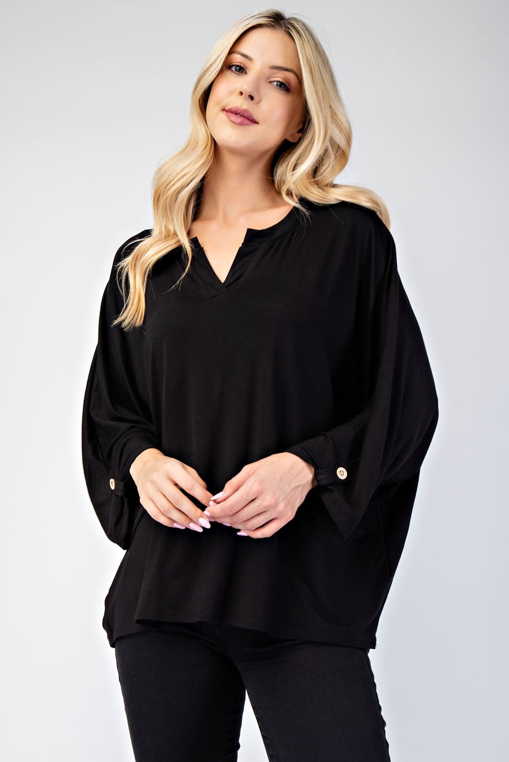 Black blouse with a notched neckline, three-quarter length sleeves, and slightly stretchy fabric.