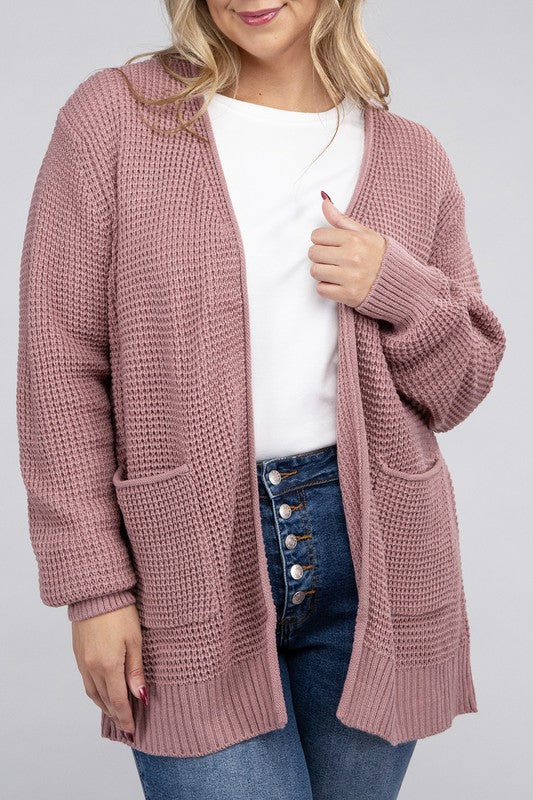 Curvy plus-size waffle-pattern open cardigan sweater in light rose, with long sleeves, oversized fit, and pockets.