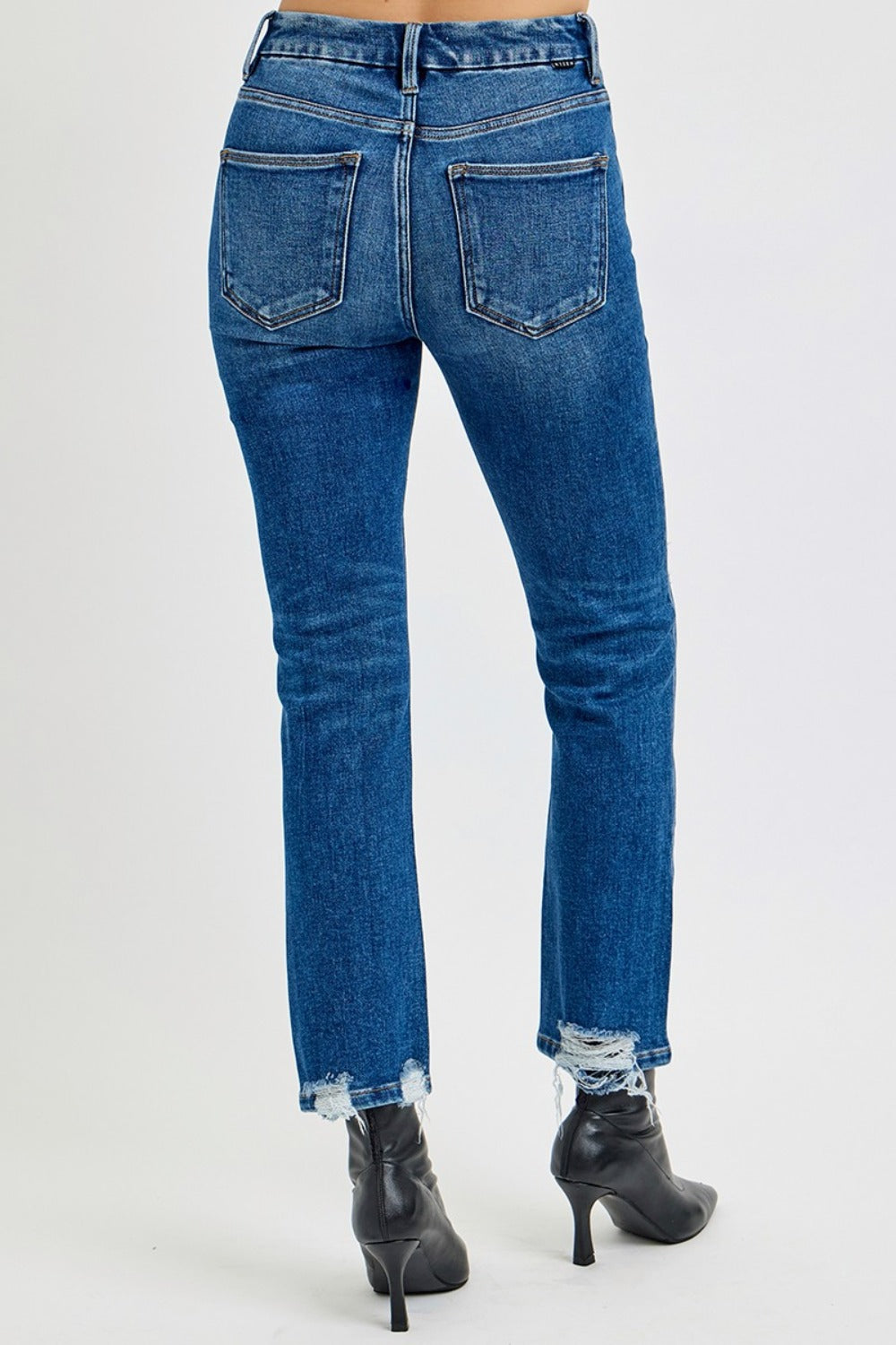 High Rise Distressed Crop Straight Jeans in dark wash with a high-rise fit, distressed details, raw hem, and slightly stretchy fabric for a cool, versatile look.