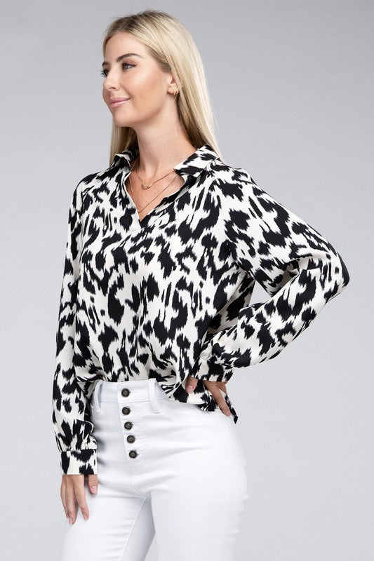 Black and white animal print collared shirt with long sleeves and a relaxed drop-shoulder design.