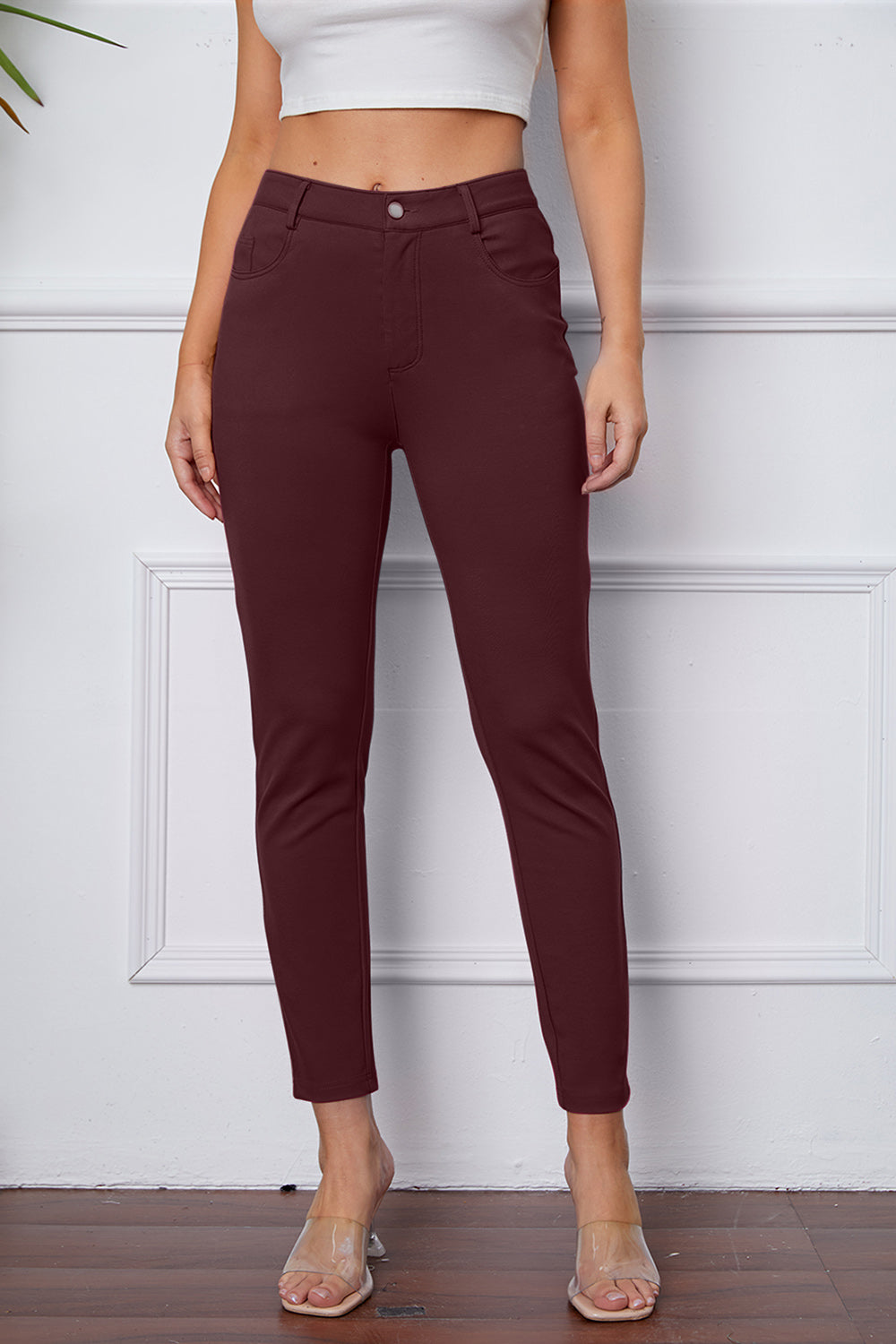 Wine stretchy high-waisted pants feature pockets, a zip fly, and belt loops. 