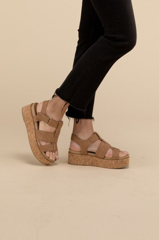 Coffee-colored platform wedge sandals with a buckle closure and 1.5" heel.