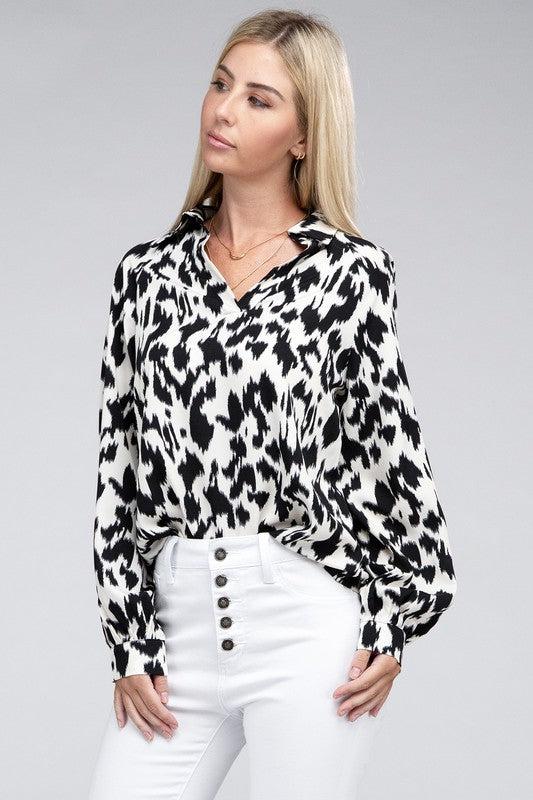 Black and white animal print collared shirt with long sleeves and a relaxed drop-shoulder design.