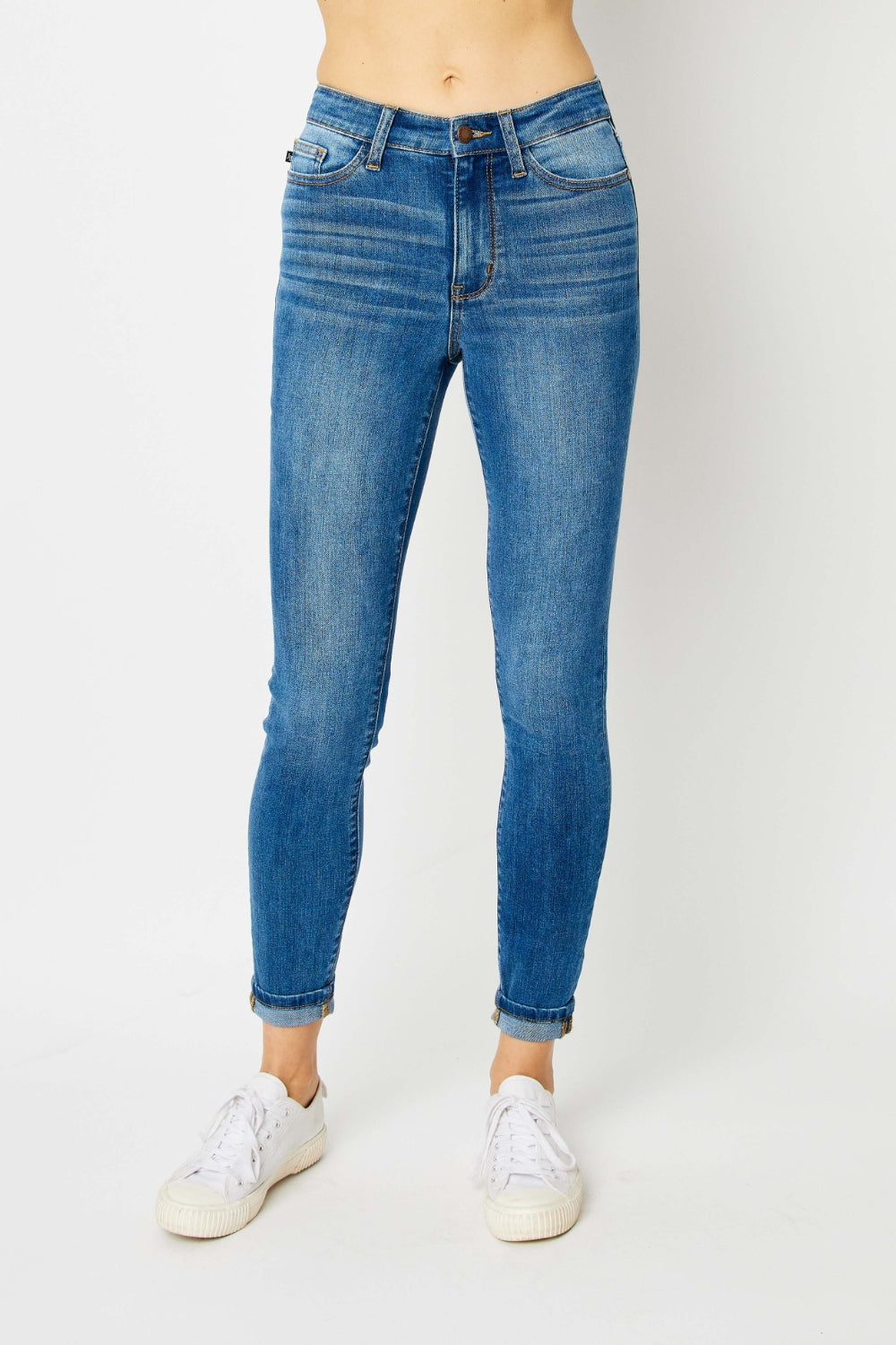 Mid-rise skinny jeans with cuffed hems and a zip fly. Medium wash with a slim fit and highly stretchy fabric.