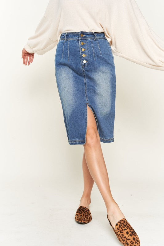 Denim button-down midi skirt with a front slit, belt loops, and back pockets. Features a high waist with an elasticized waistband in the back.