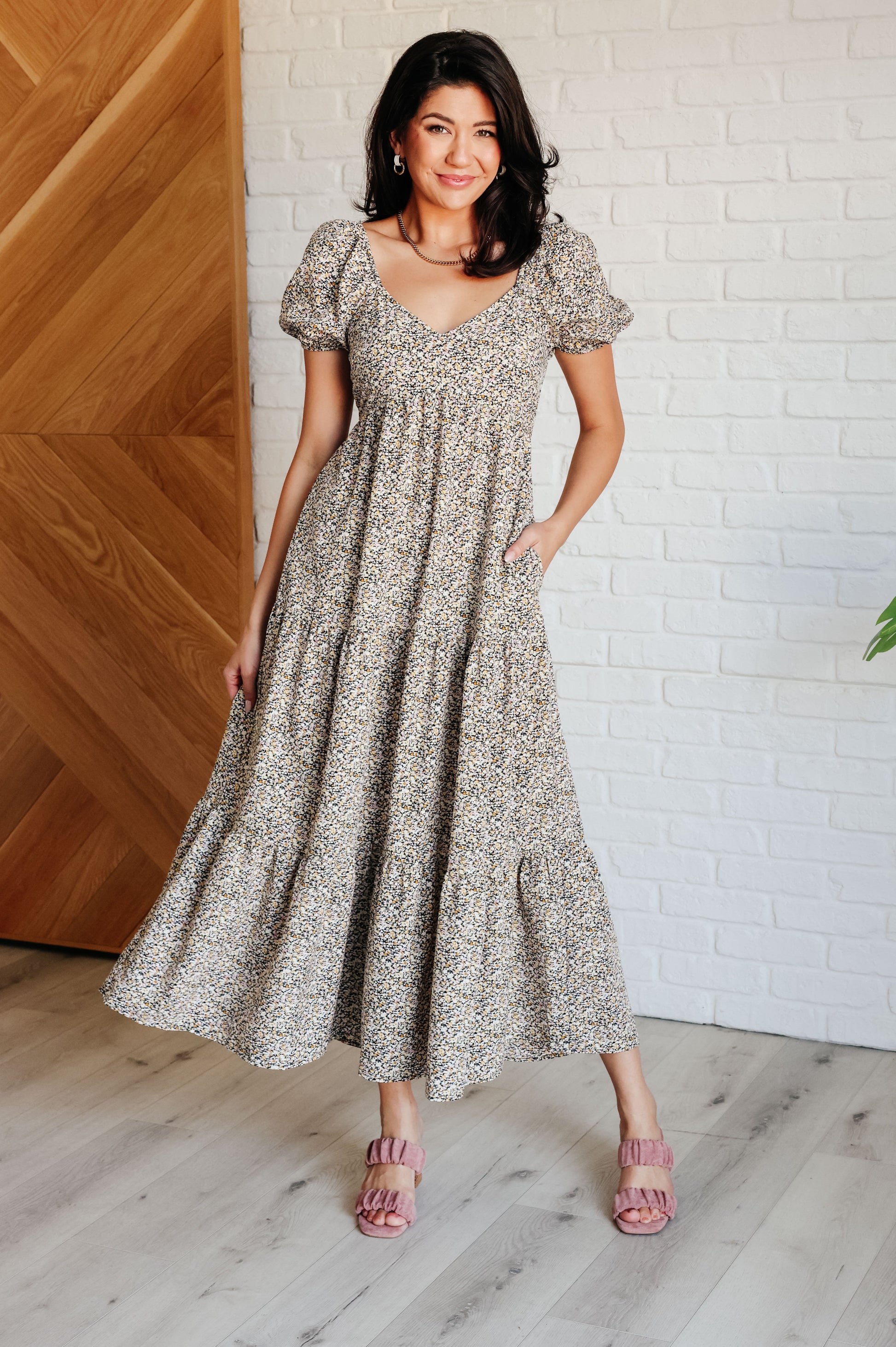 A maxi dress with a sweetheart neckline, short balloon sleeves, and a tiered skirt. Made from soft woven poplin with cased elastic details and functional side pockets.