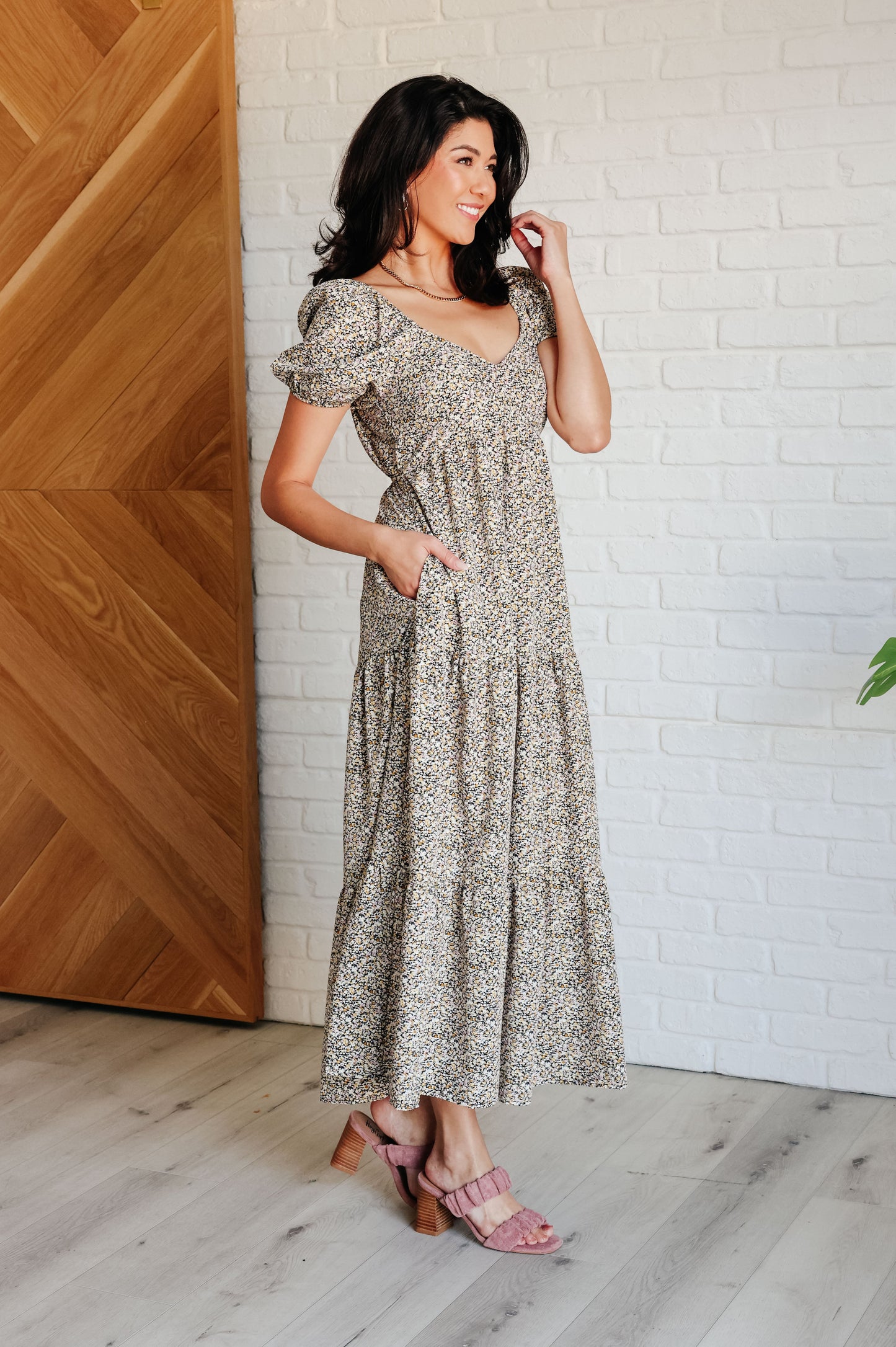 A maxi dress with a sweetheart neckline, short balloon sleeves, and a tiered skirt. Made from soft woven poplin with cased elastic details and functional side pockets.