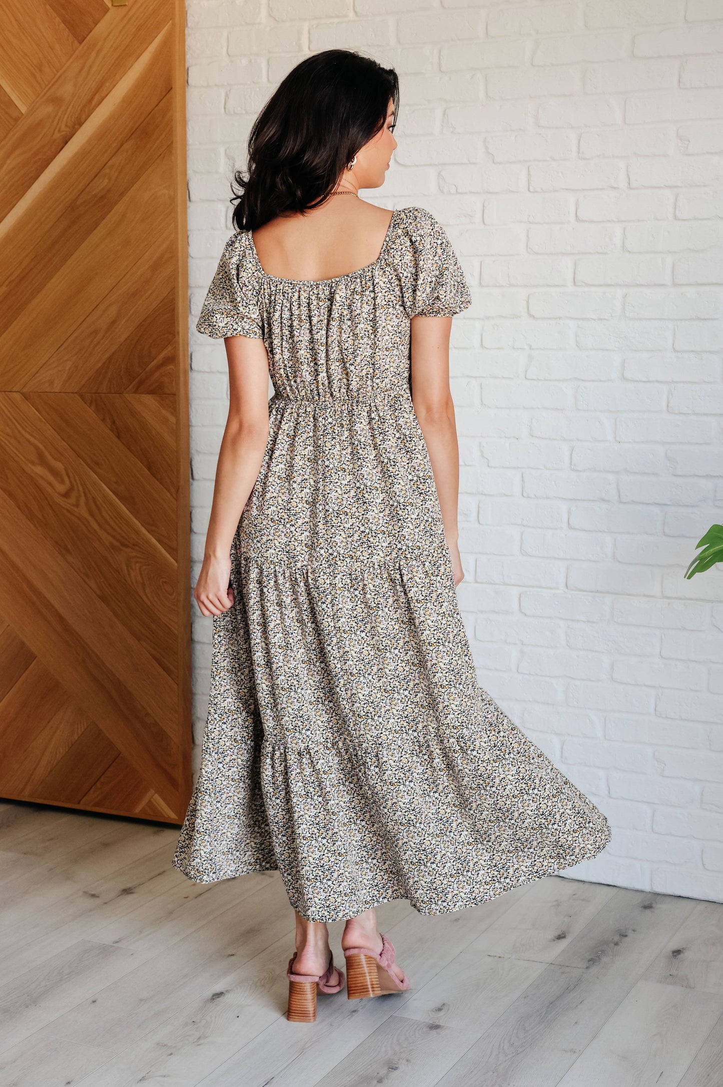 A maxi dress with a sweetheart neckline, short balloon sleeves, and a tiered skirt. Made from soft woven poplin with cased elastic details and functional side pockets.