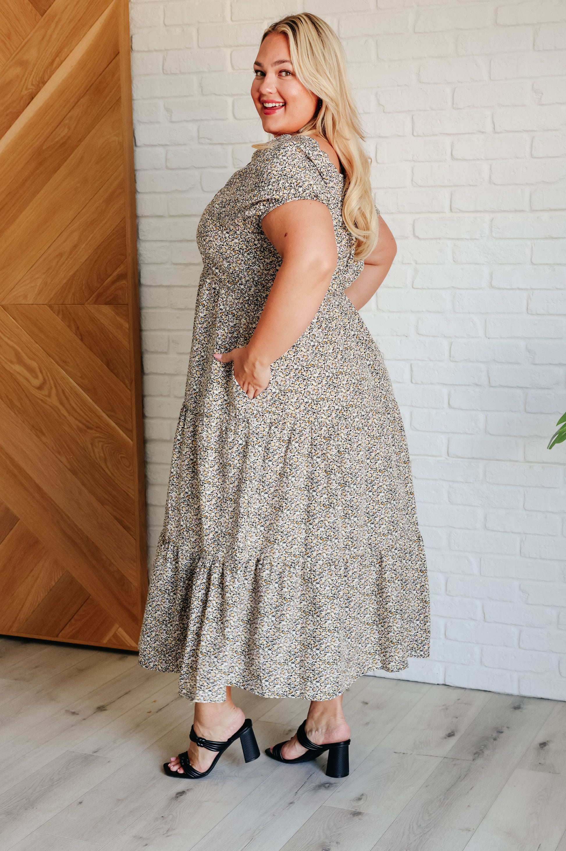 A maxi dress with a sweetheart neckline, short balloon sleeves, and a tiered skirt. Made from soft woven poplin with cased elastic details and functional side pockets.