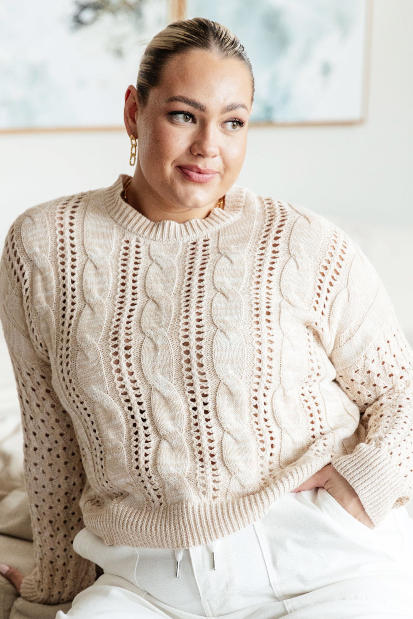 Plus size front view of Natalia Cream Cable Knit Sweater with round neckline, ribbed hem, and drop shoulder design.