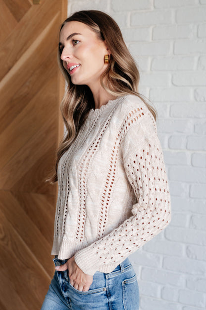 Side view of Natalia Cream Cable Knit Sweater, showing drop shoulder design and cozy medium-weight knit fabric.