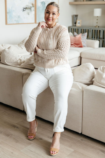 Plus size close-up of Natalia Cable Knit Sweater neckline with ribbed detail, soft cream cotton blend fabric.