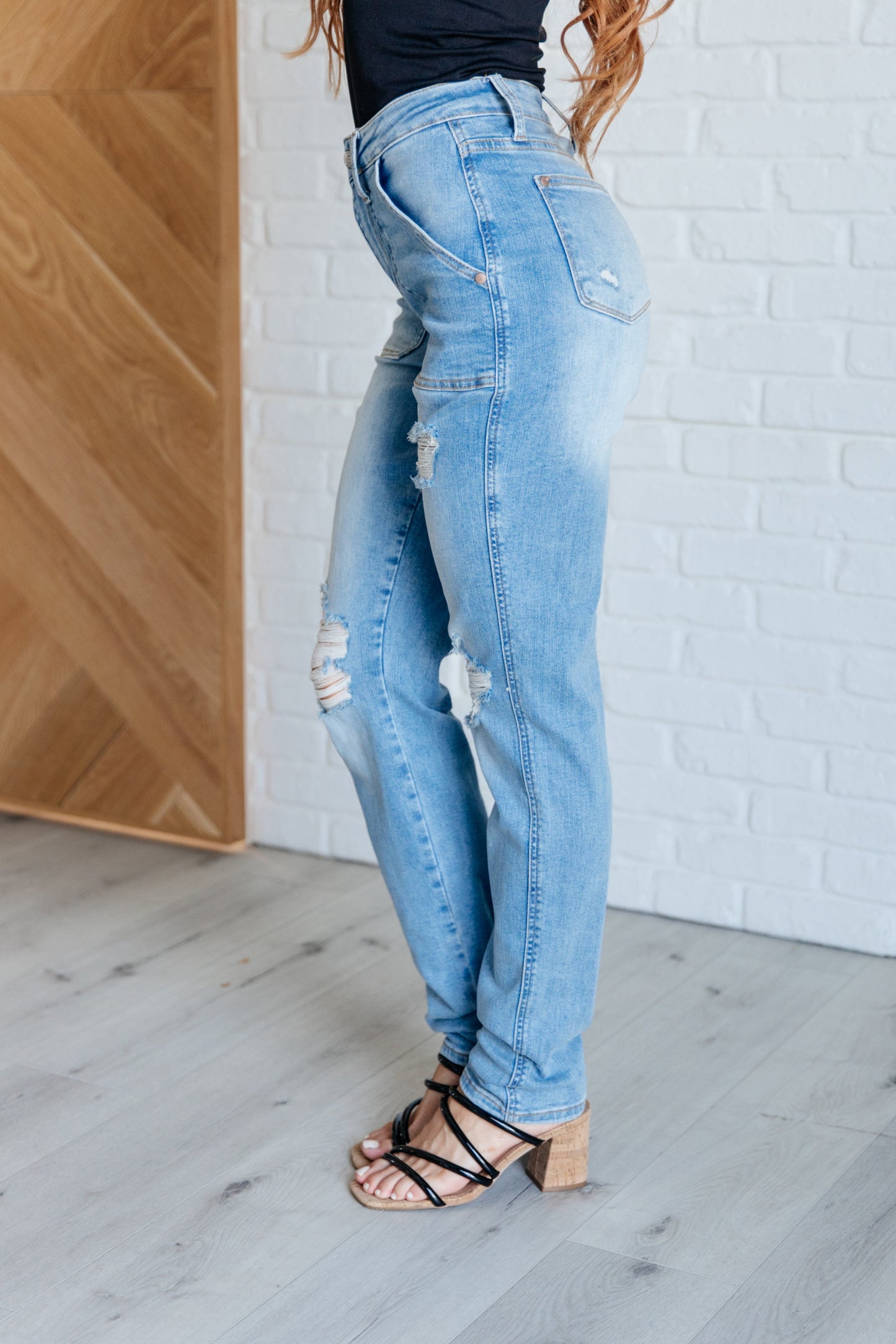 Light wash high-rise boyfriend jeans with patch pockets, distressed details, and optional cuffed hem