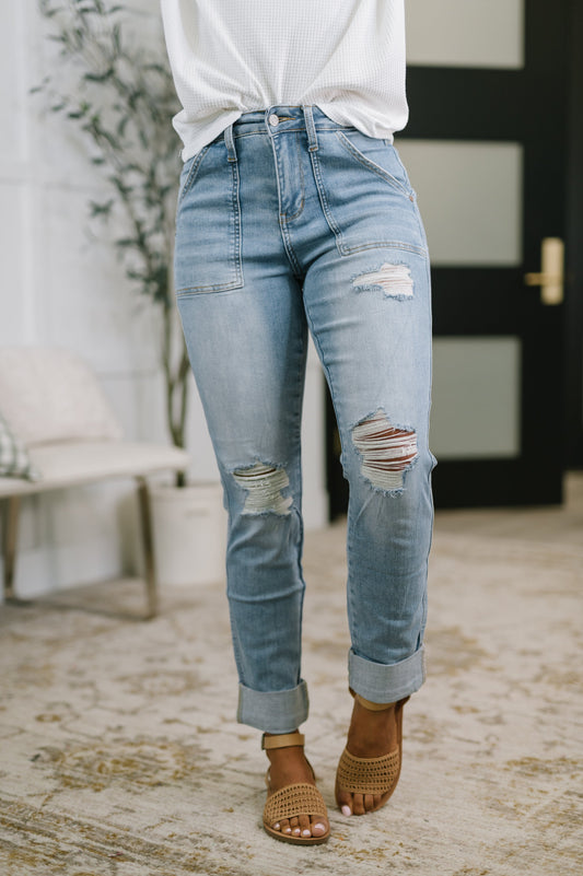 Model wearing Aiden High Rise Patch Pocket Distressed Boyfriend Jeans by Judy Blue light wash denim.
