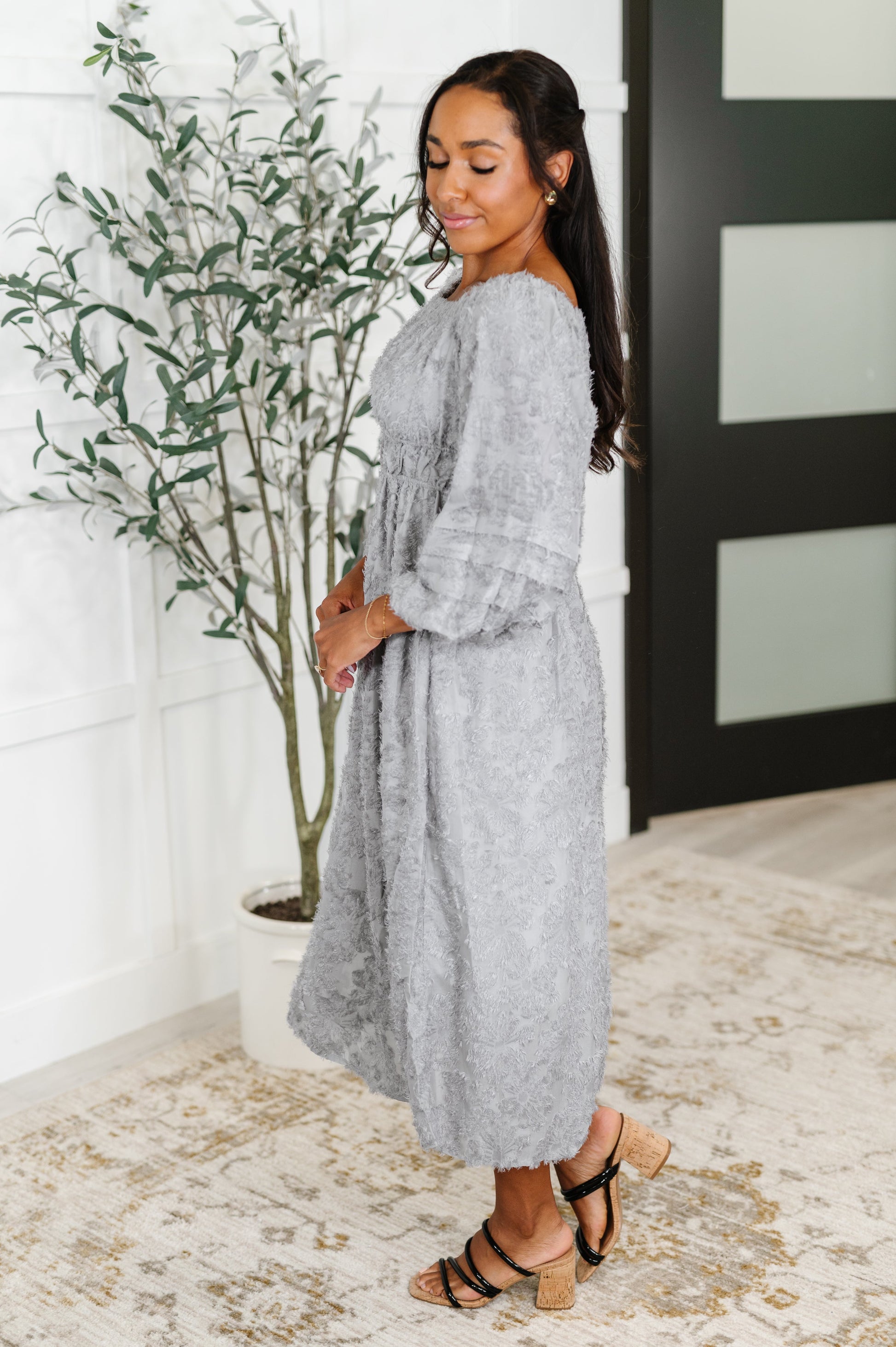 Side view of Janelle Off Shoulder Floral Chiffon Midi Dress showcasing flowy chiffon fabric, peasant sleeve, and empire waistline.
