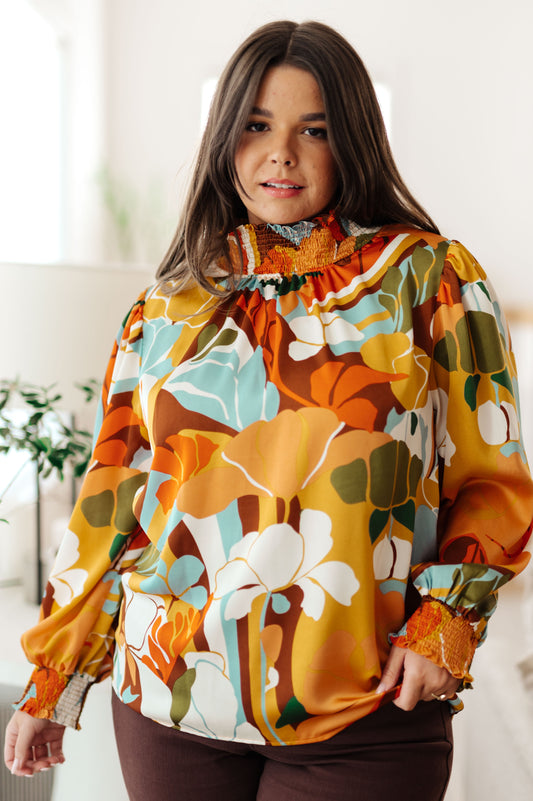 Plus size front view of Dylan Mock Neck Blouse with tangerine floral satin fabric and smocked neckline