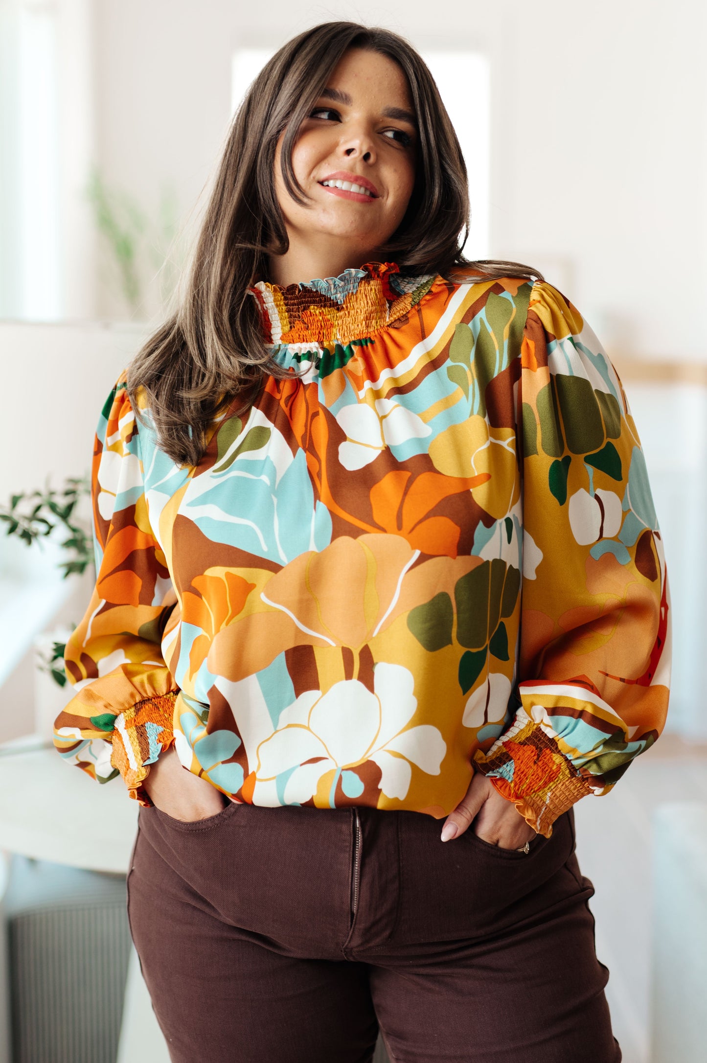 Plus size front view of Dylan Mock Neck Blouse highlighting satin shine, smocked neckline, and floral print