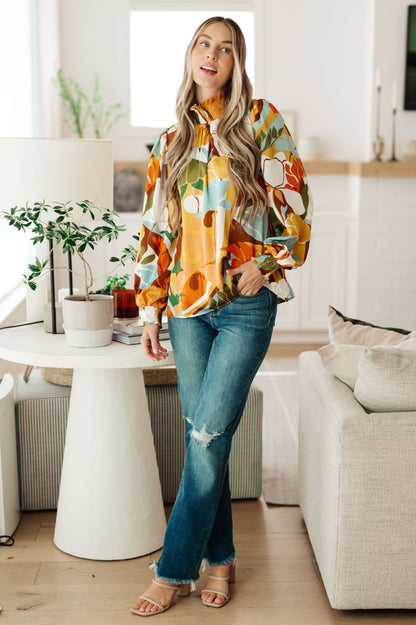 Full body view of model wearing Dylan Mock Neck Blouse styled with jeans for casual chic floral look