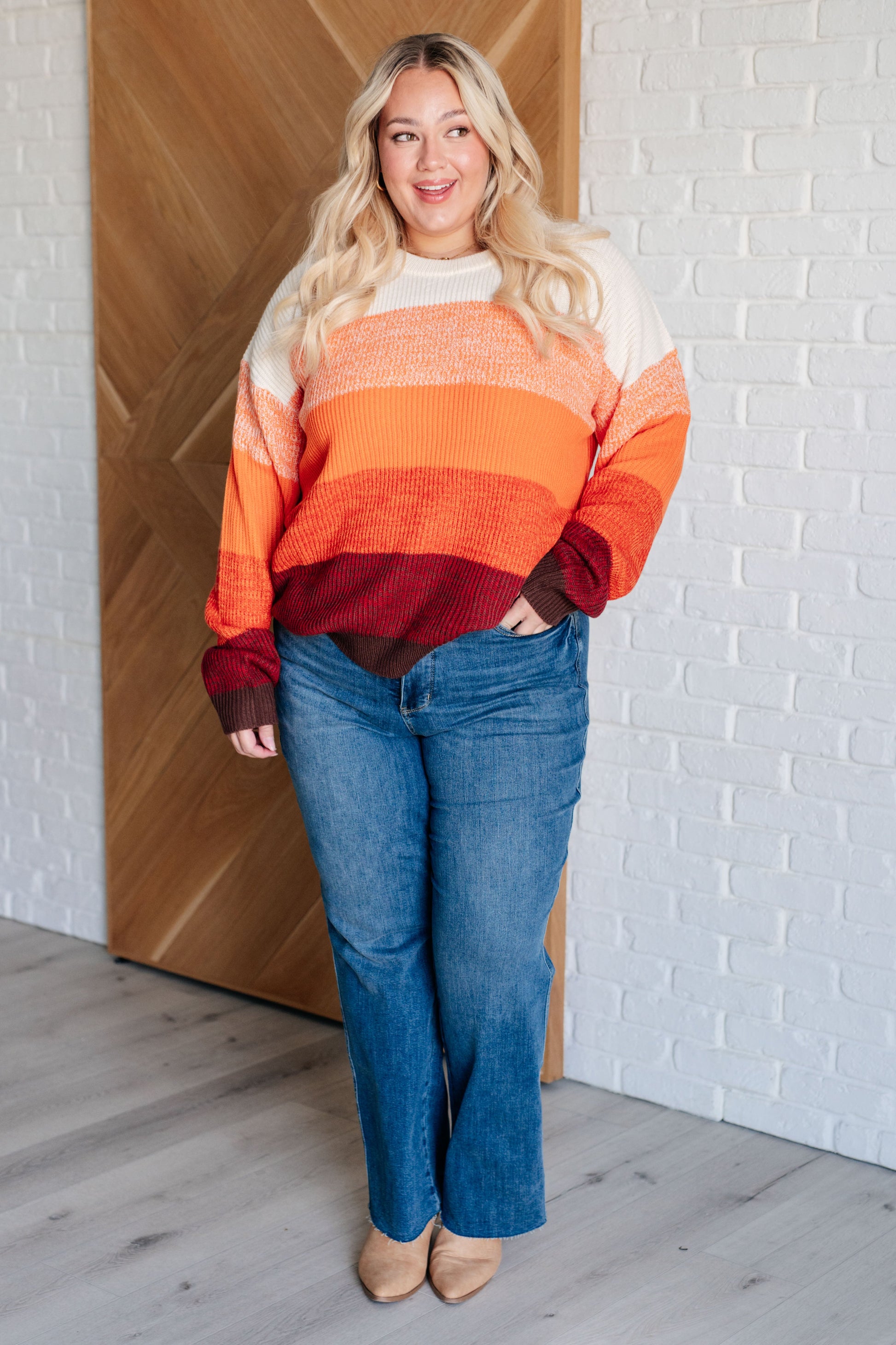 Women's oversized color block sweater with a banded ribbed round neckline, long drop-shoulder sleeves, and sweater knit fabric in white, peach, orange, red, and brown tones.