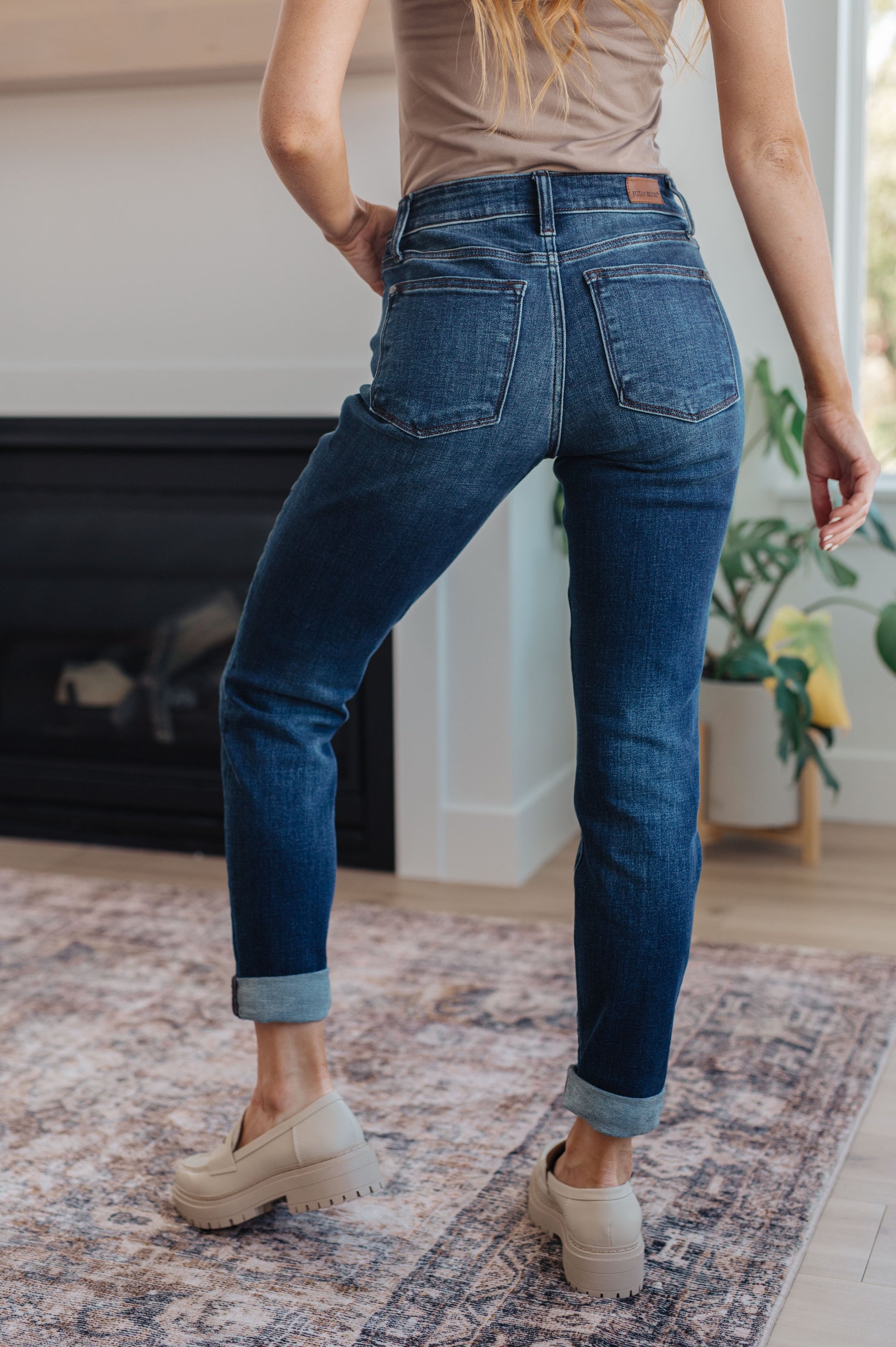 Back view of the Judy Blue Amber cuffed jeans styled with boots – mid-rise, 4-way stretch comfort.