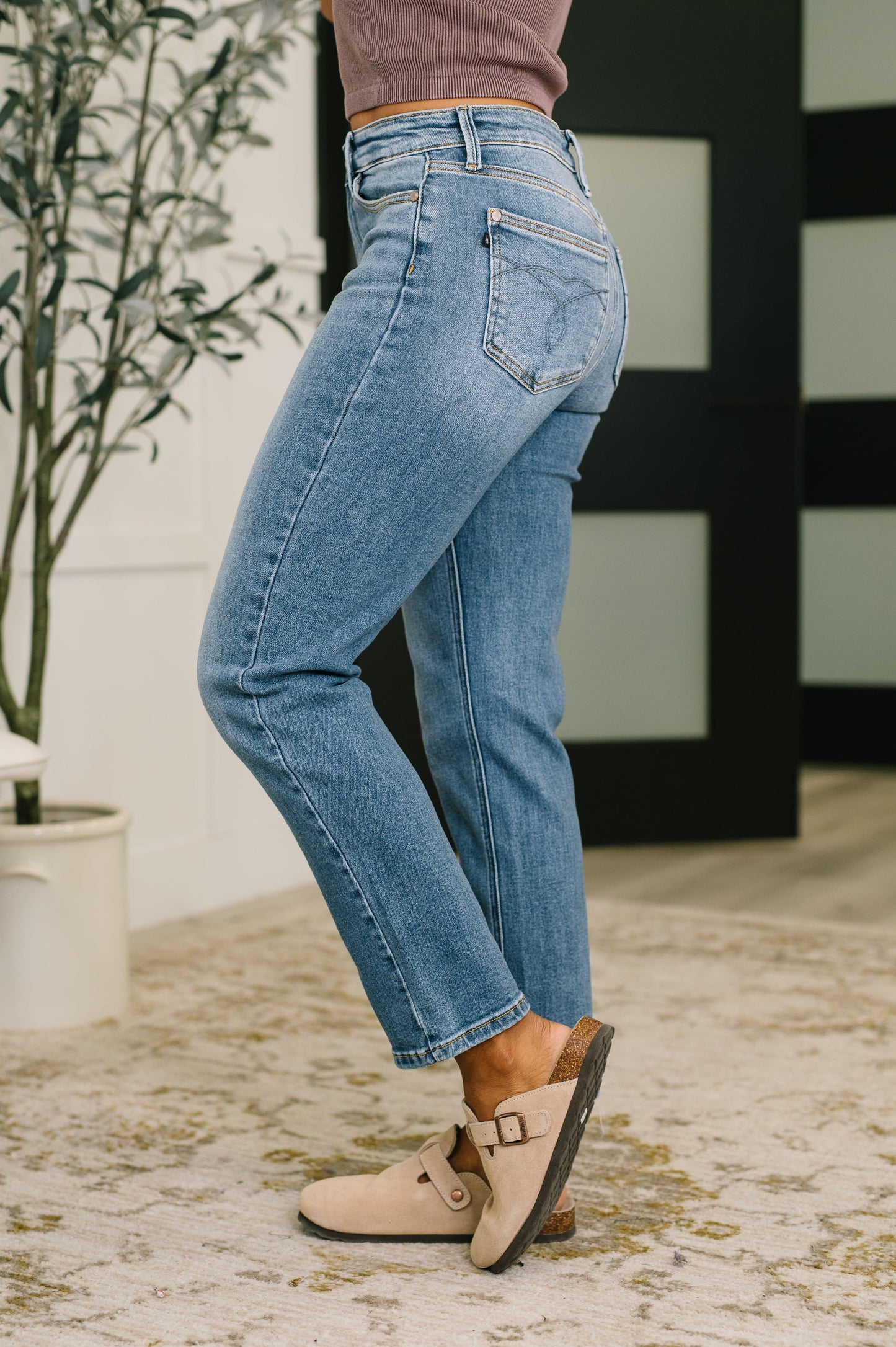 Side angle of Amelia High Waist Ankle Straight Jeans highlighting ankle straight leg.