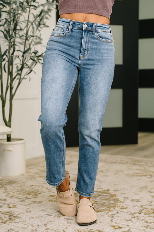 Model wearing Amelia High Waist Ankle Straight Jeans in medium wash by Judy Blue.