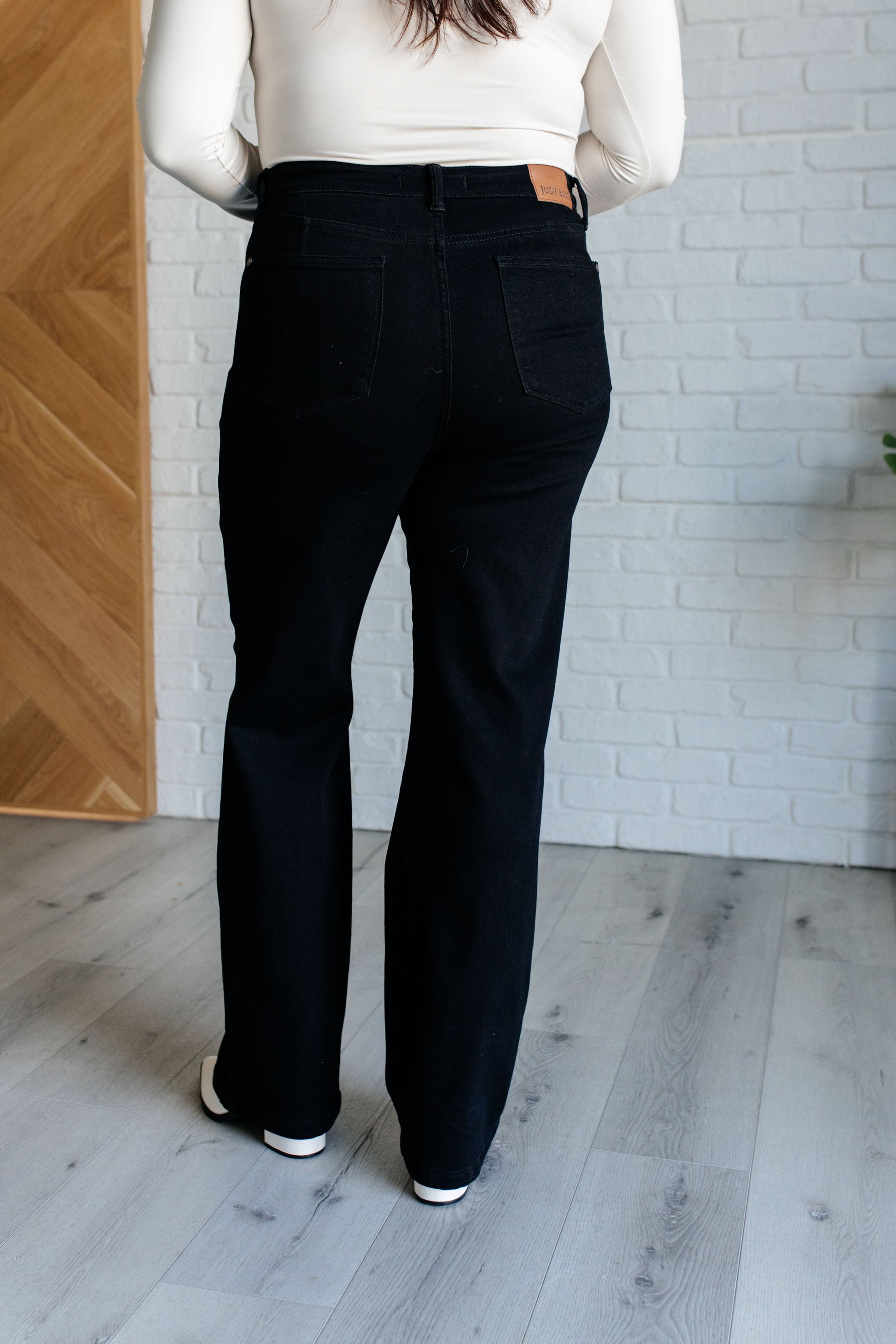 High Rise Control Top Classic Straight Jeans in black wash. Features tummy control, zip fly closure, non-distressed, and classic straight leg silhouette.