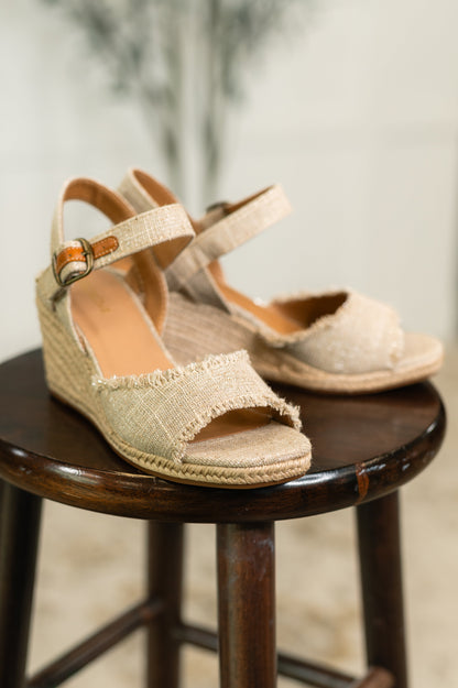 Arnold natural linen wedges highlighting braided twine sole, canvas texture, and 3 1/8" wedge heel.